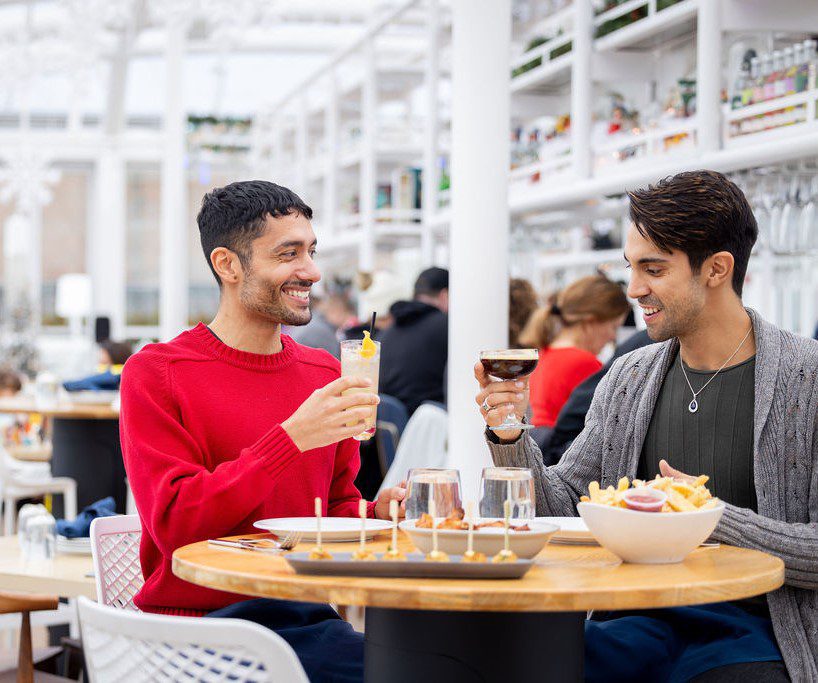 Couple enjoying beverage at Love at the Pier.