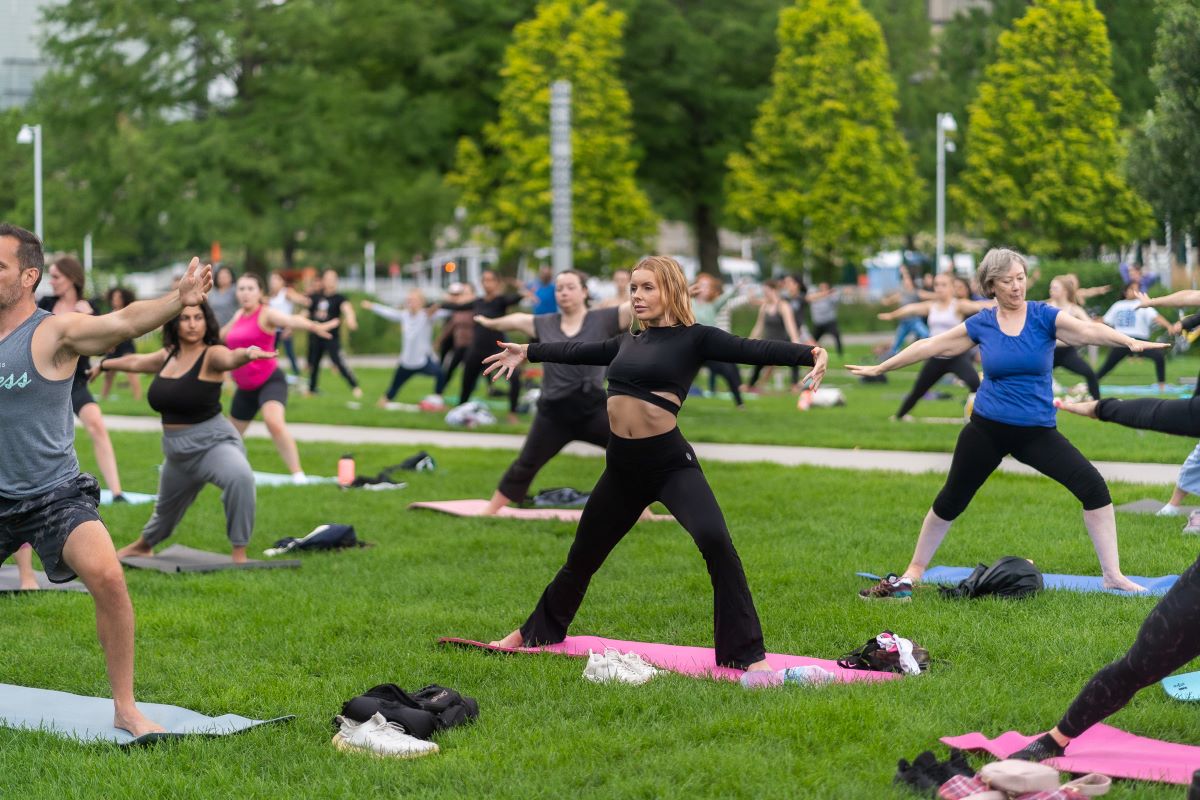 Outdoor yoga session at Pier Fitness event on Navy Pier’s lakefront lawn