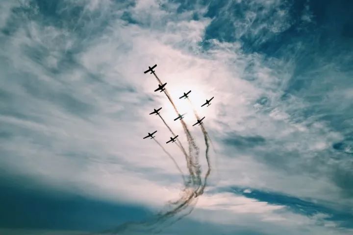 Squadron formation with smoke trails against dramatic sky near Navy Pier